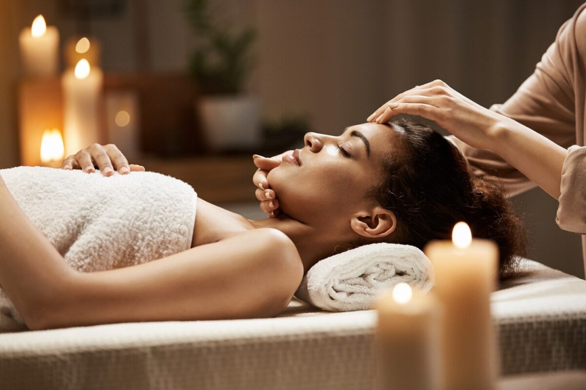 attractive-african-woman-enjoying-face-massage-spa-salon_176420-13955