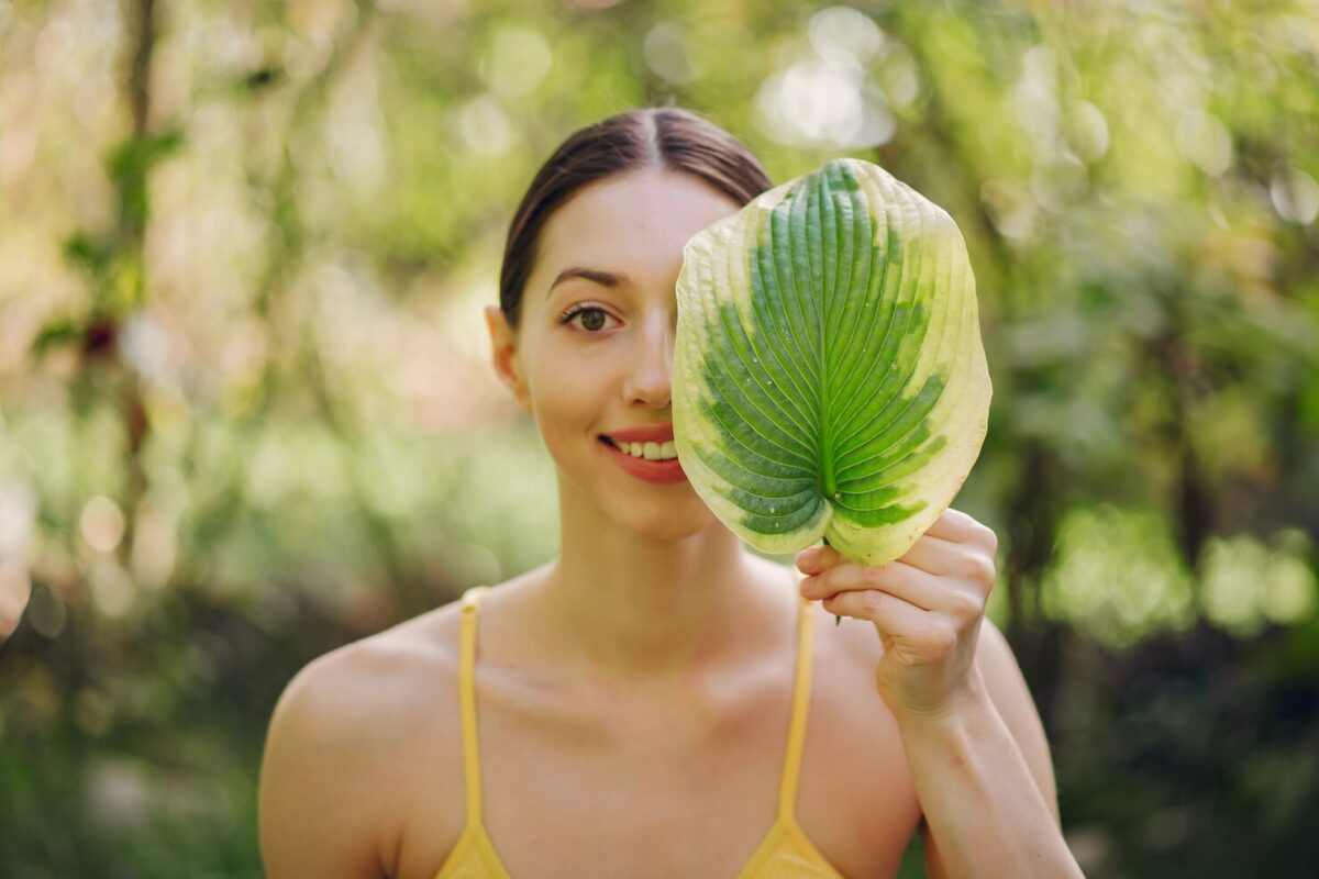 girl-holding-green-leaf-near-her-face_1157-30812-1200x800.jpg